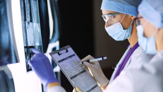 Two female women medical doctors looking at x-rays in a hospital